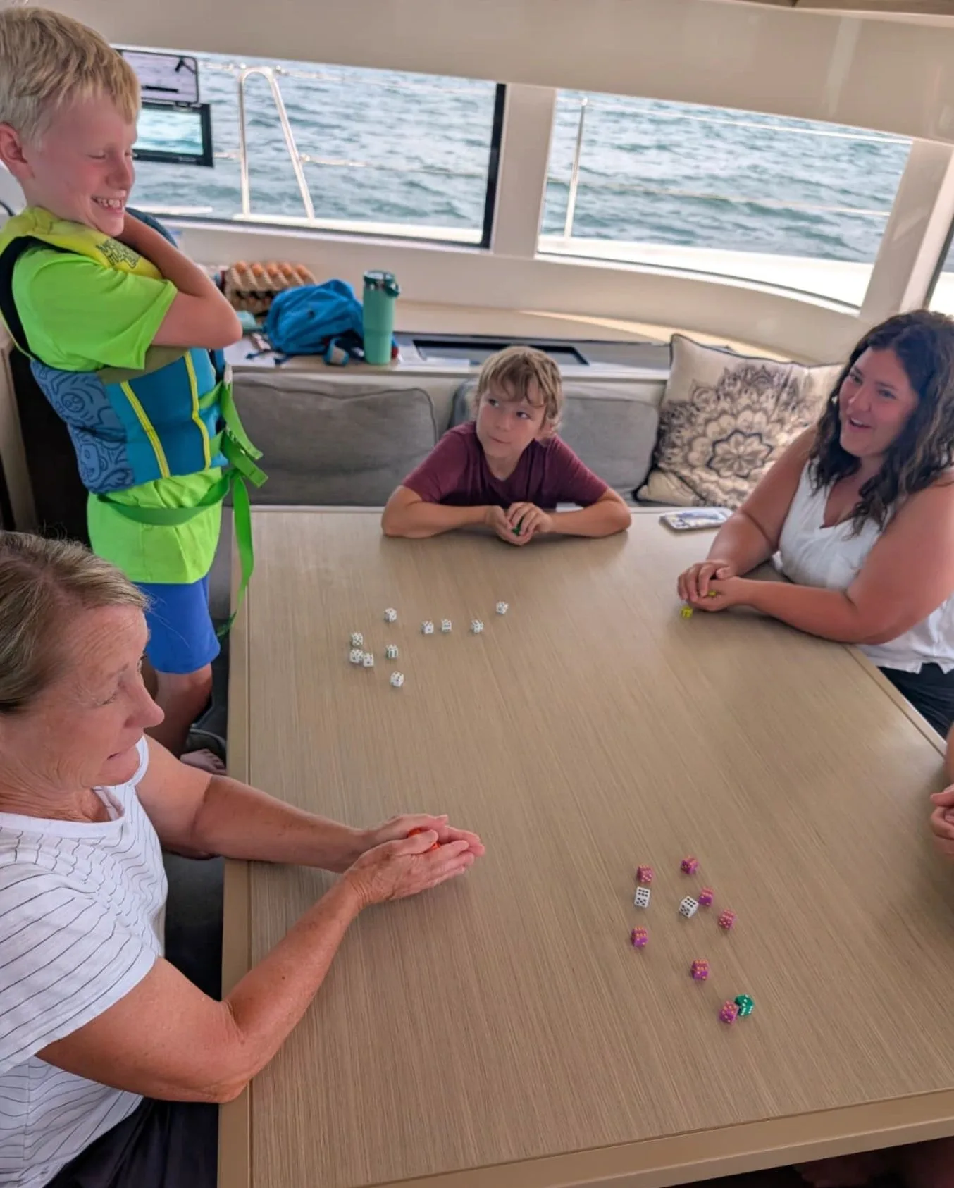 Family time around the table aboard a yacht