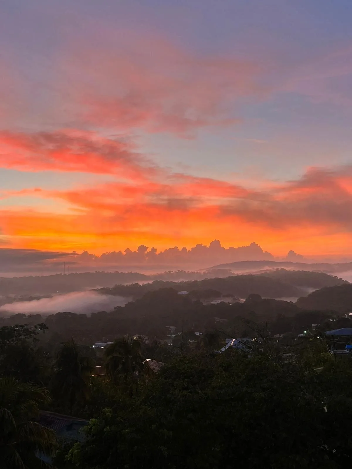 Colourful sunset above Belize’s green hills