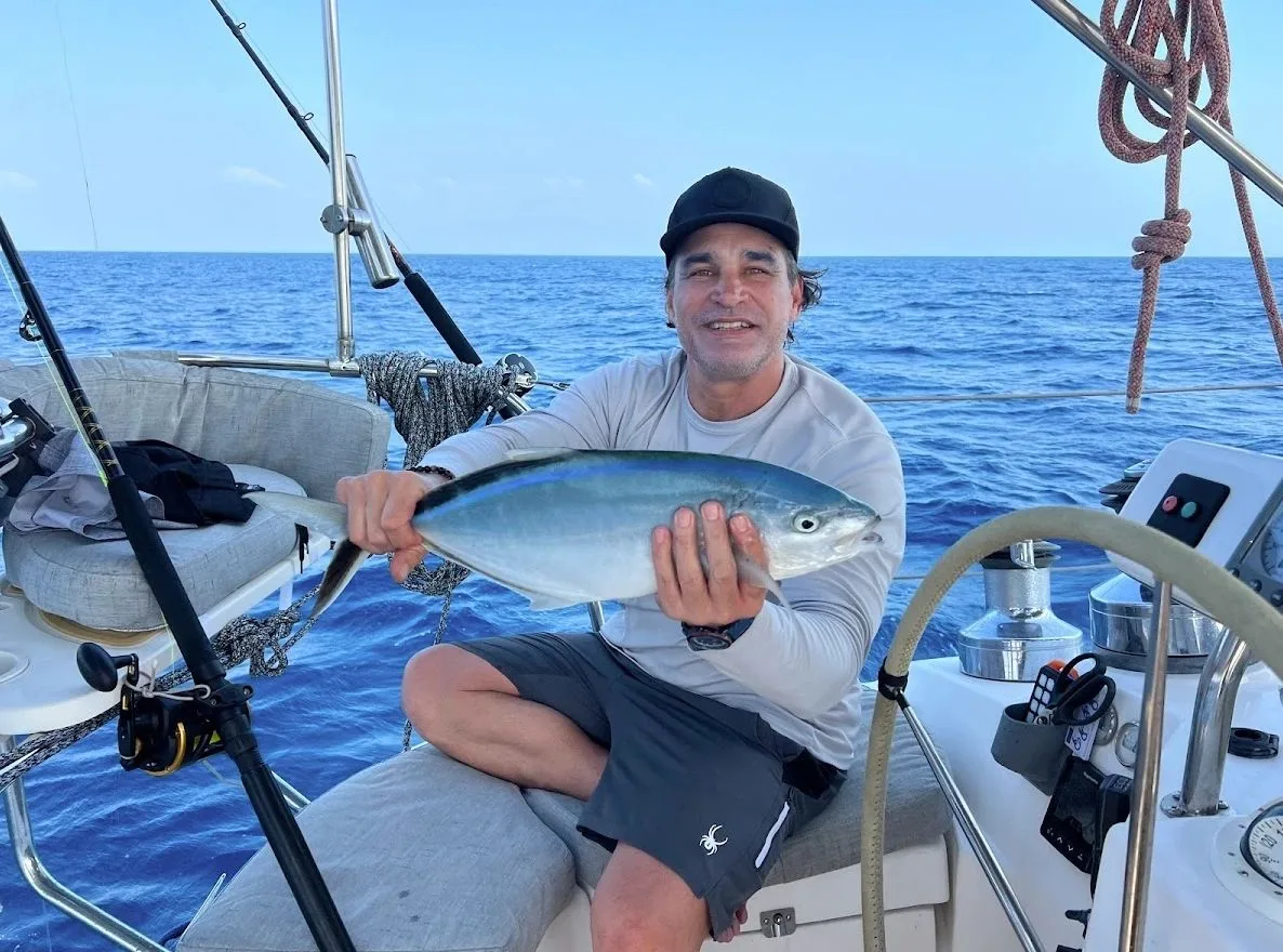 Guest holding a fish caught from the yacht