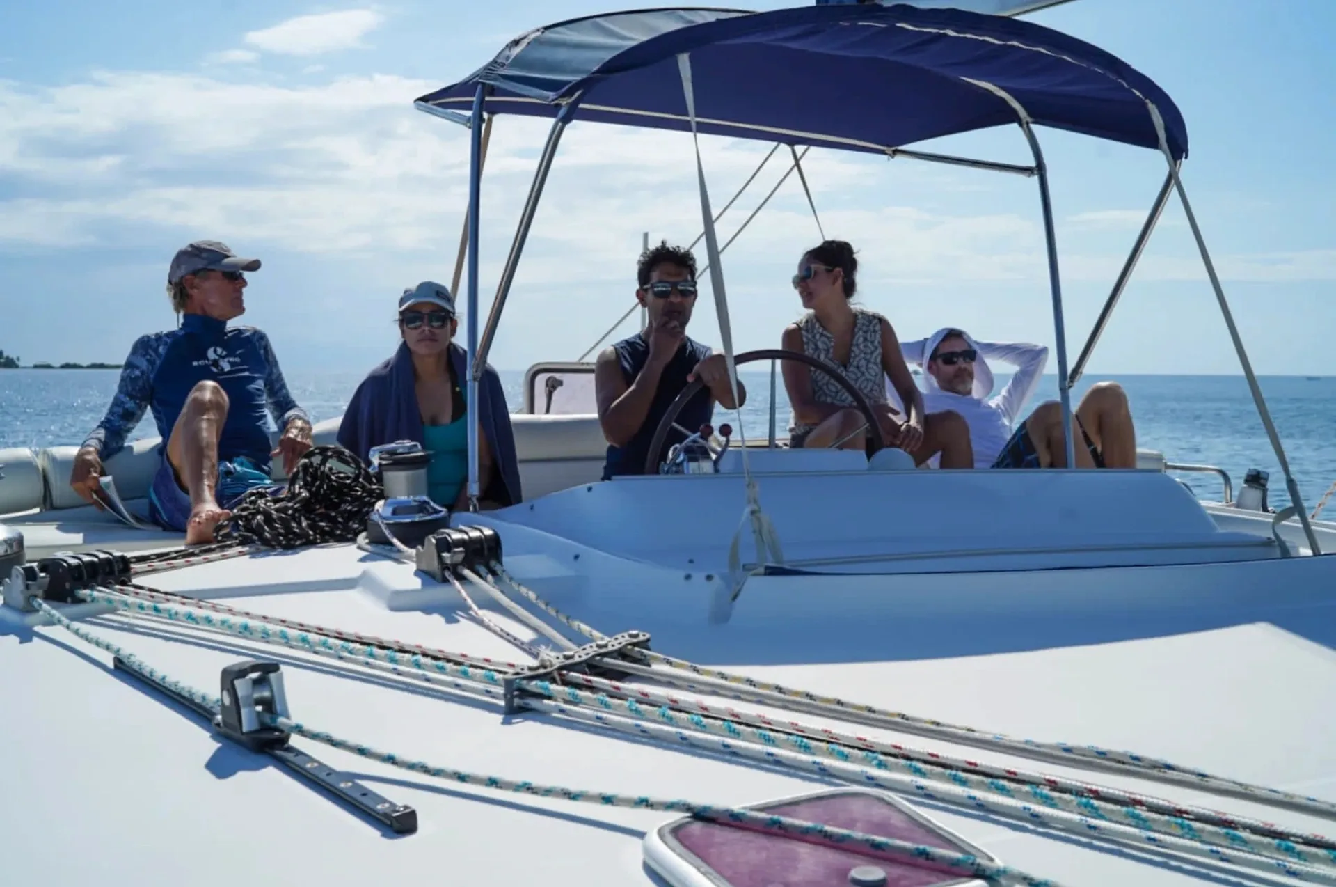 Sailing students and their instructor gathered at the helm