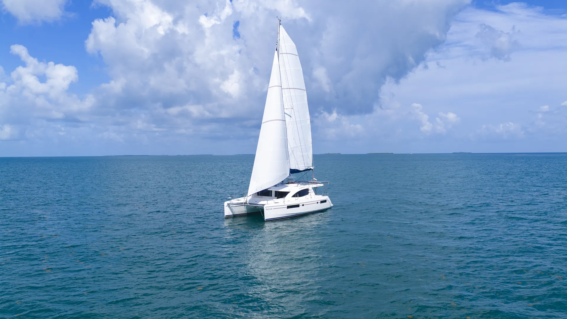 Sailing catamaran crossing open Belize water