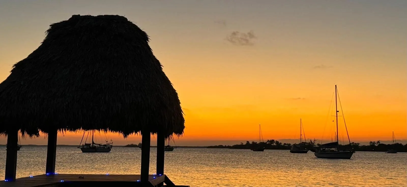 Sunset over sailboats in Placencia, Belize