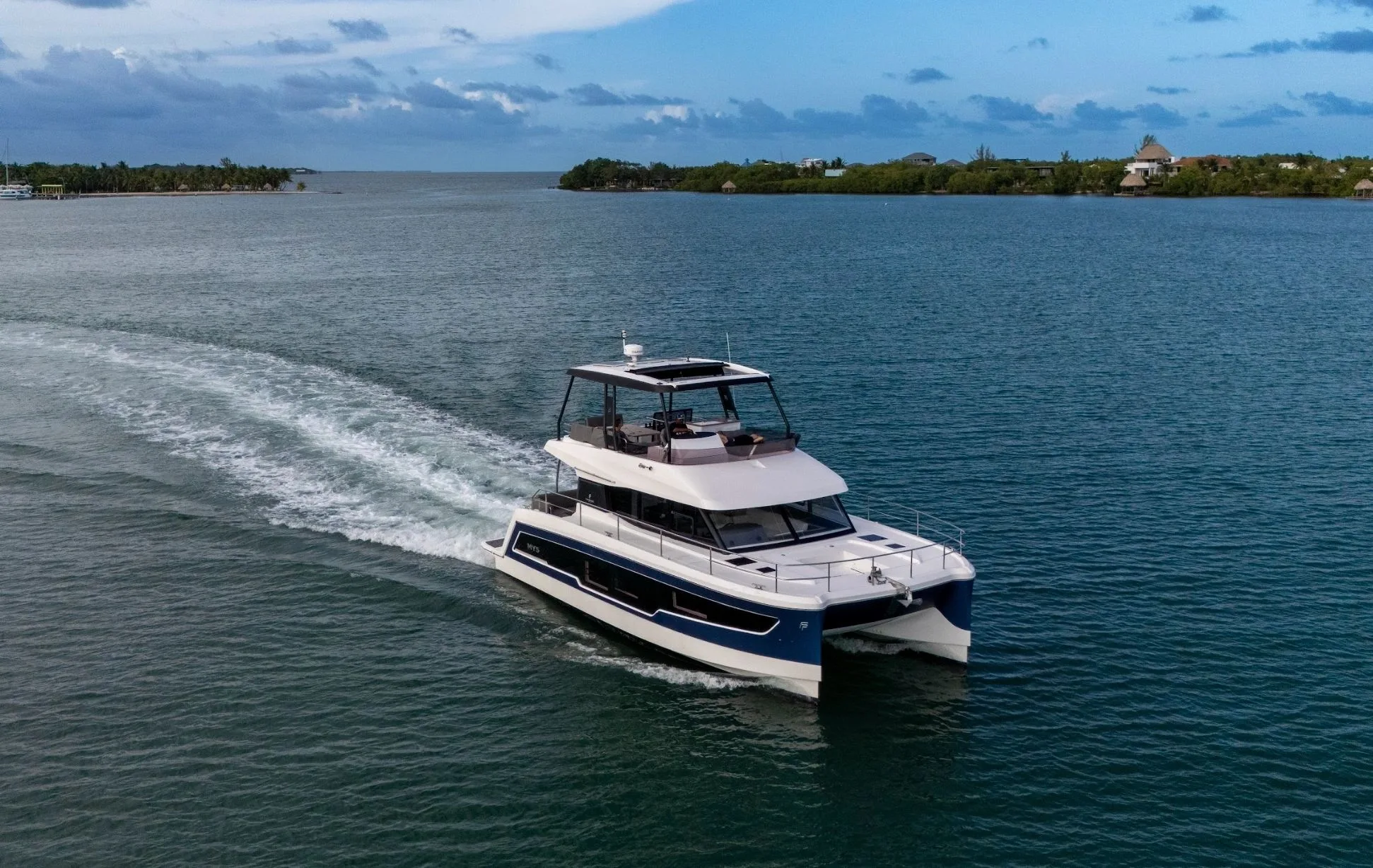 Placencia Yacht Charters power yacht moving through Belizean water